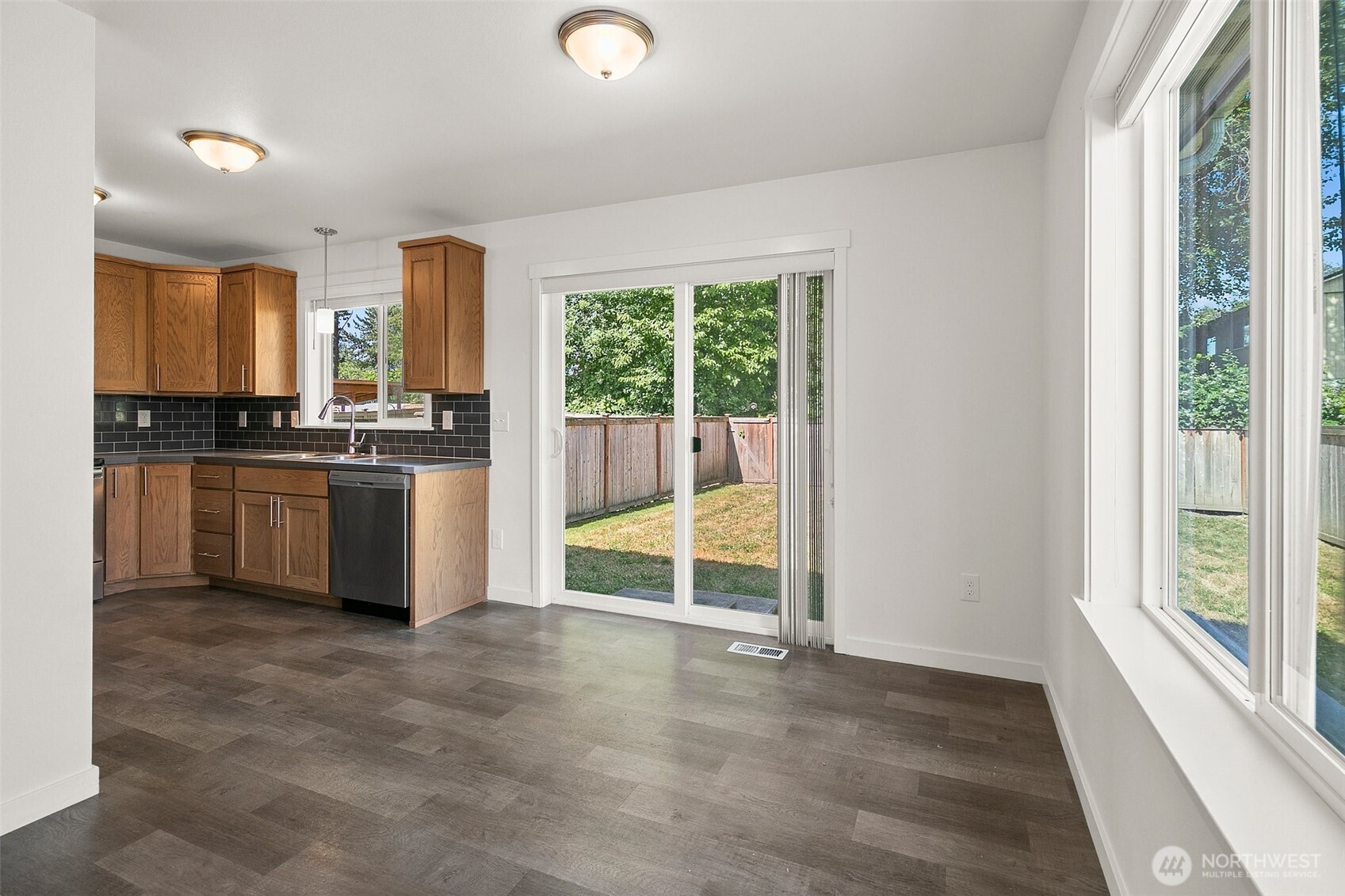 709 3rd Avenue South Kent, WA 98032 - Photo 11 of 26 a kitchen with stainless steel appliances granite countertop a stove a sink and a refrigerator