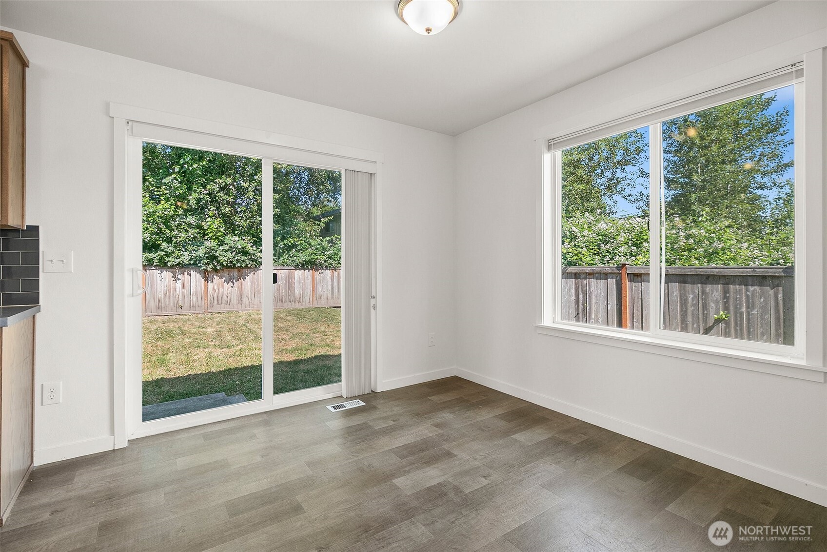 709 3rd Avenue South Kent, WA 98032 - Photo 12 of 26 a view of an empty room with wooden floor and a window