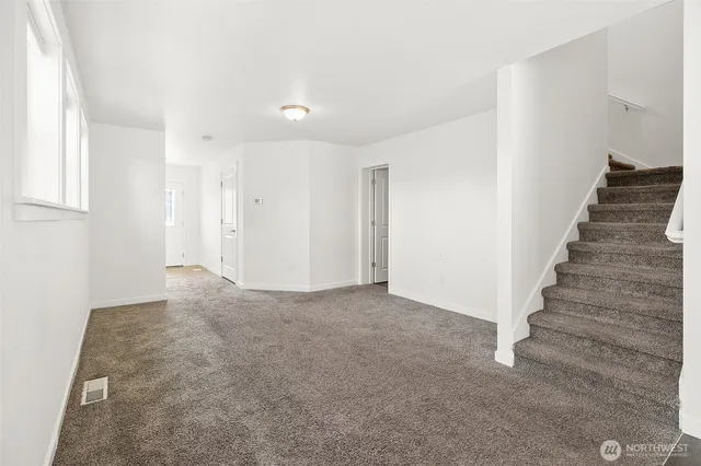 a kitchen with a sink cabinets appliances and a window