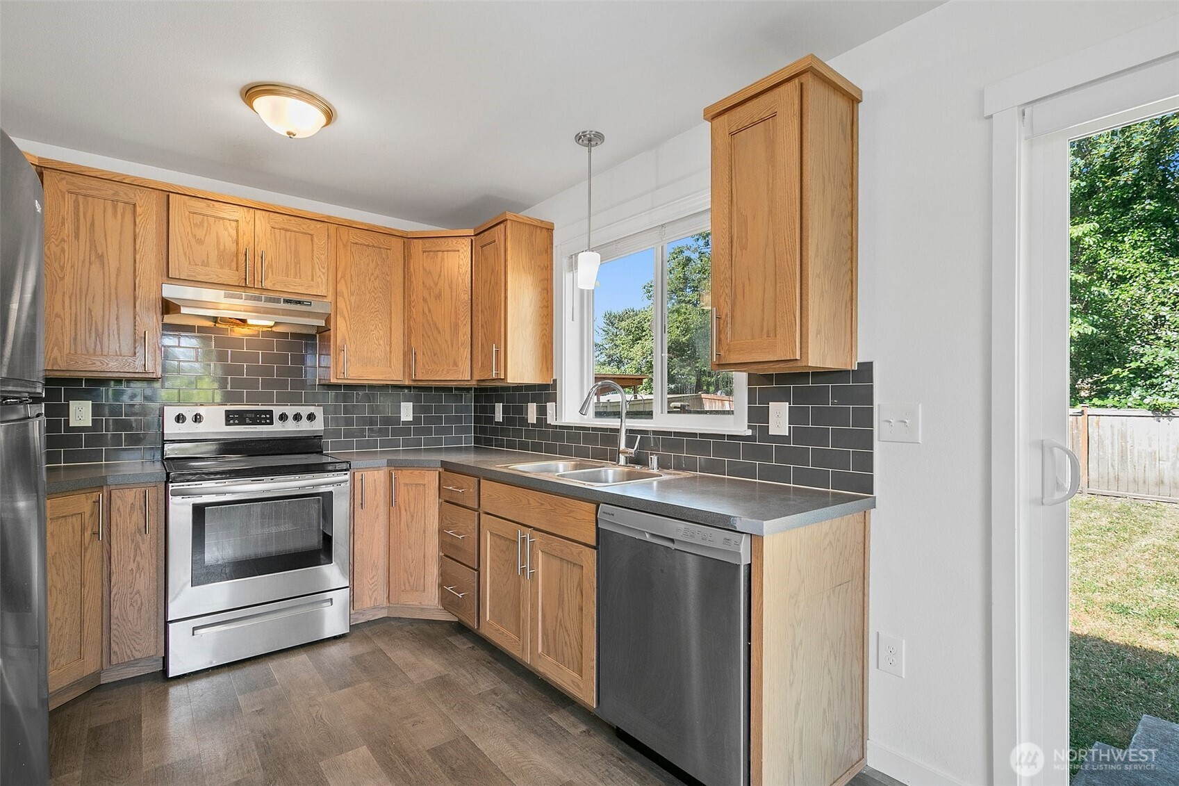 709 3rd Avenue South Kent, WA 98032 - Photo 8 of 26 a kitchen with a sink cabinets appliances and a window