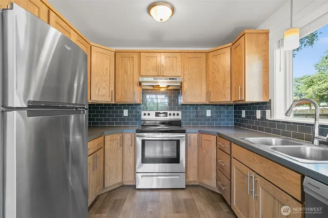 a kitchen with a sink and large window