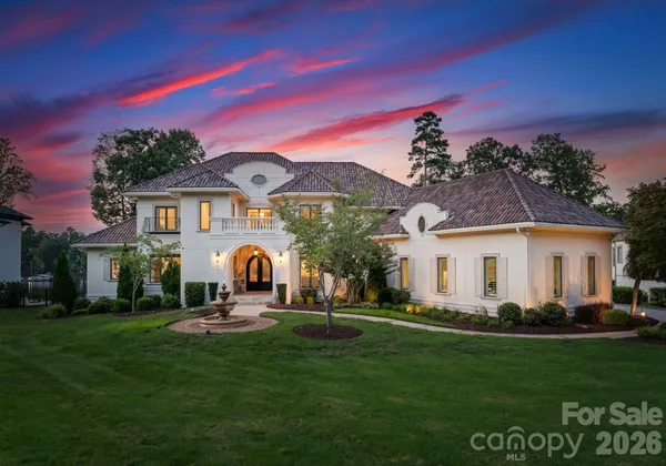 a front view of a house with a garden and yard