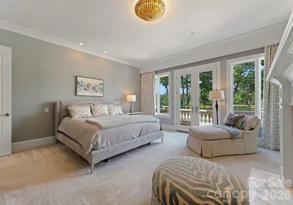 a bedroom with a bed and a large window