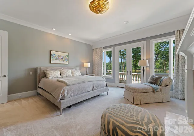 a bedroom with a bed and a large window