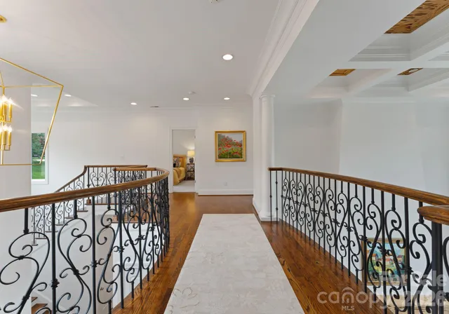 a view of hallway with wooden floor