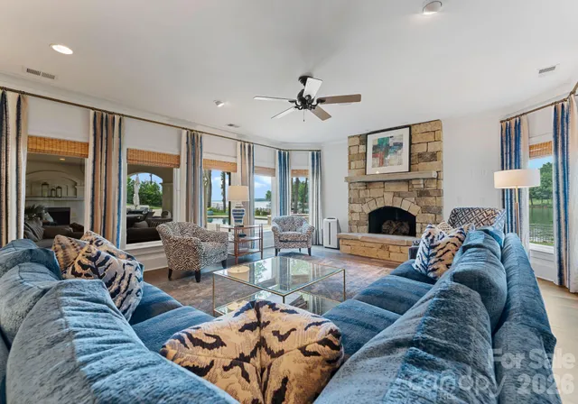 a living room with furniture large window and a fireplace