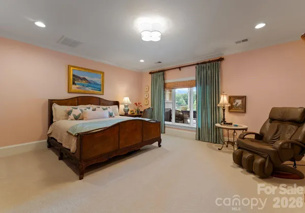 a bedroom with a bed and glass window
