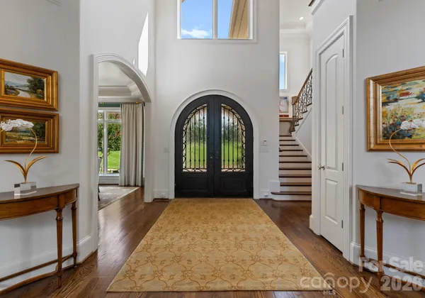 a view of a livingroom with wooden floor and furniture