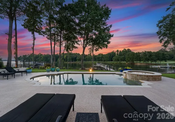 a view of house with swimming pool and sitting area