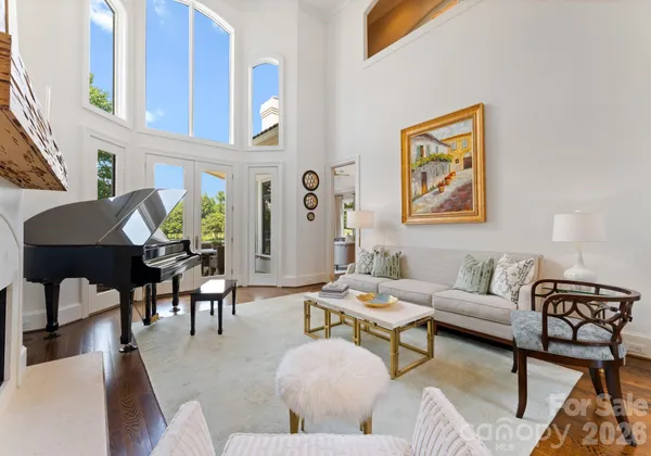 a living room with furniture and painting on the wall next to a window