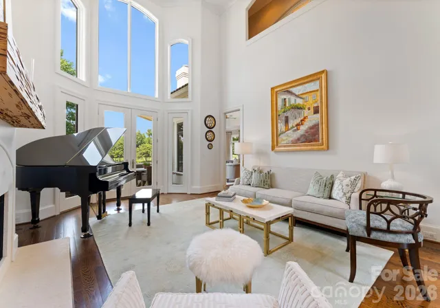 a living room with furniture and painting on the wall next to a window