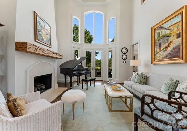 a living room with furniture a fireplace and a wall painting