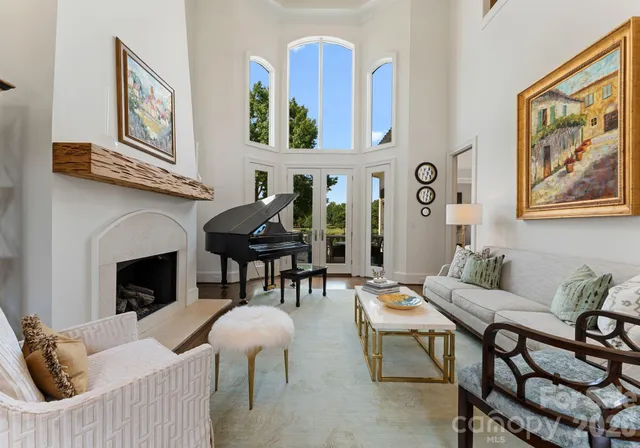 a living room with furniture a fireplace and a wall painting