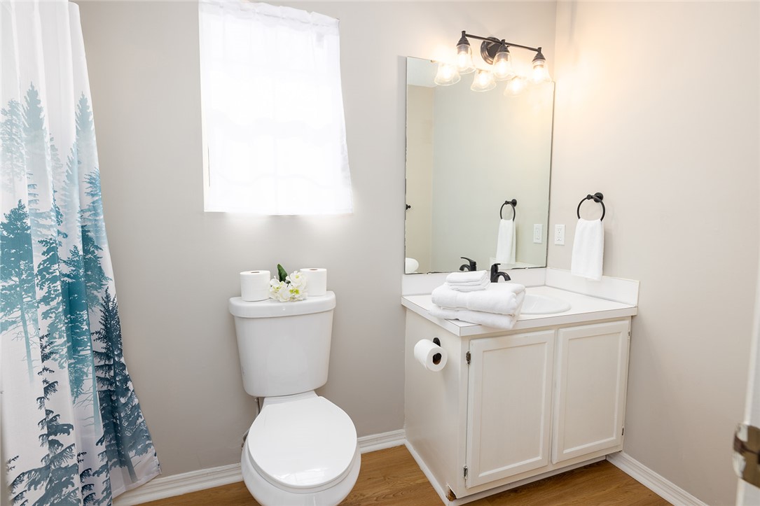 410 South Cove Road Seneca, SC 29672 - Photo 21 of 25 Bright bathroom with a single vanity and window, offering a functional and clean space.