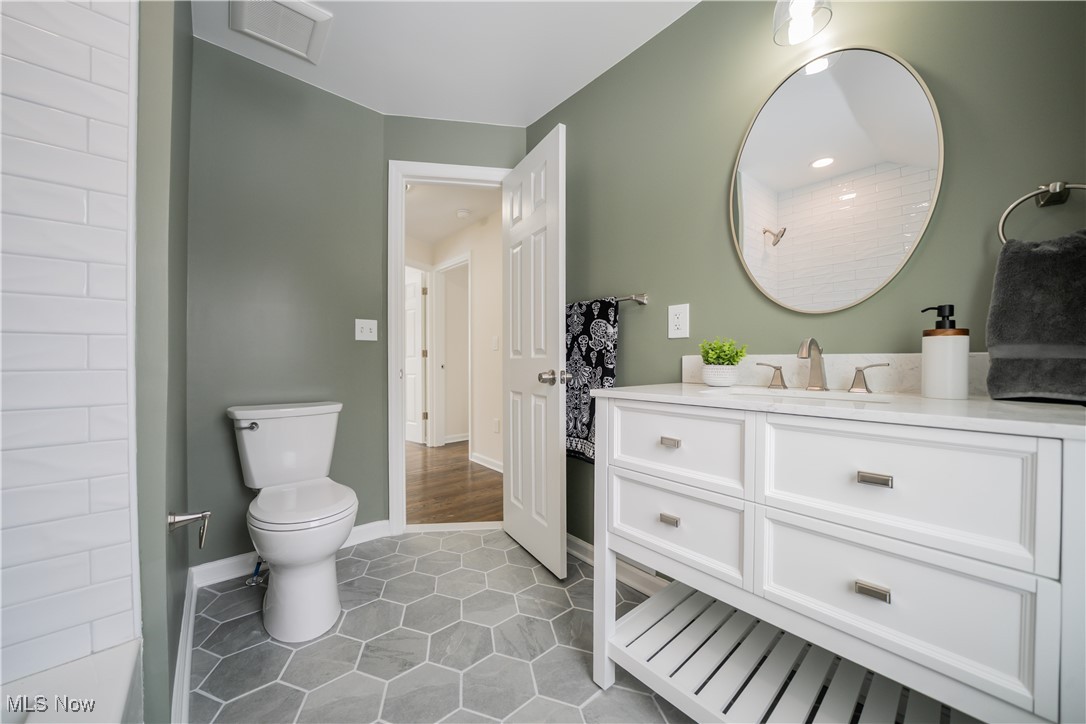 2279 North Taylor Road Cleveland, OH 44112 - Photo 16 of 35 Full bathroom with toilet, vanity, and tile patterned floors