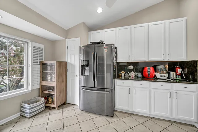 a kitchen with stainless steel appliances granite countertop a refrigerator and a stove