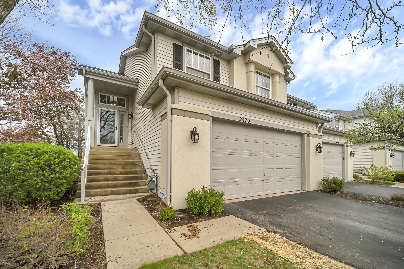 2470 Palazzo Court Buffalo Grove, IL 60089 - Photo 2 of 31 a front view of a house with a yard and garage