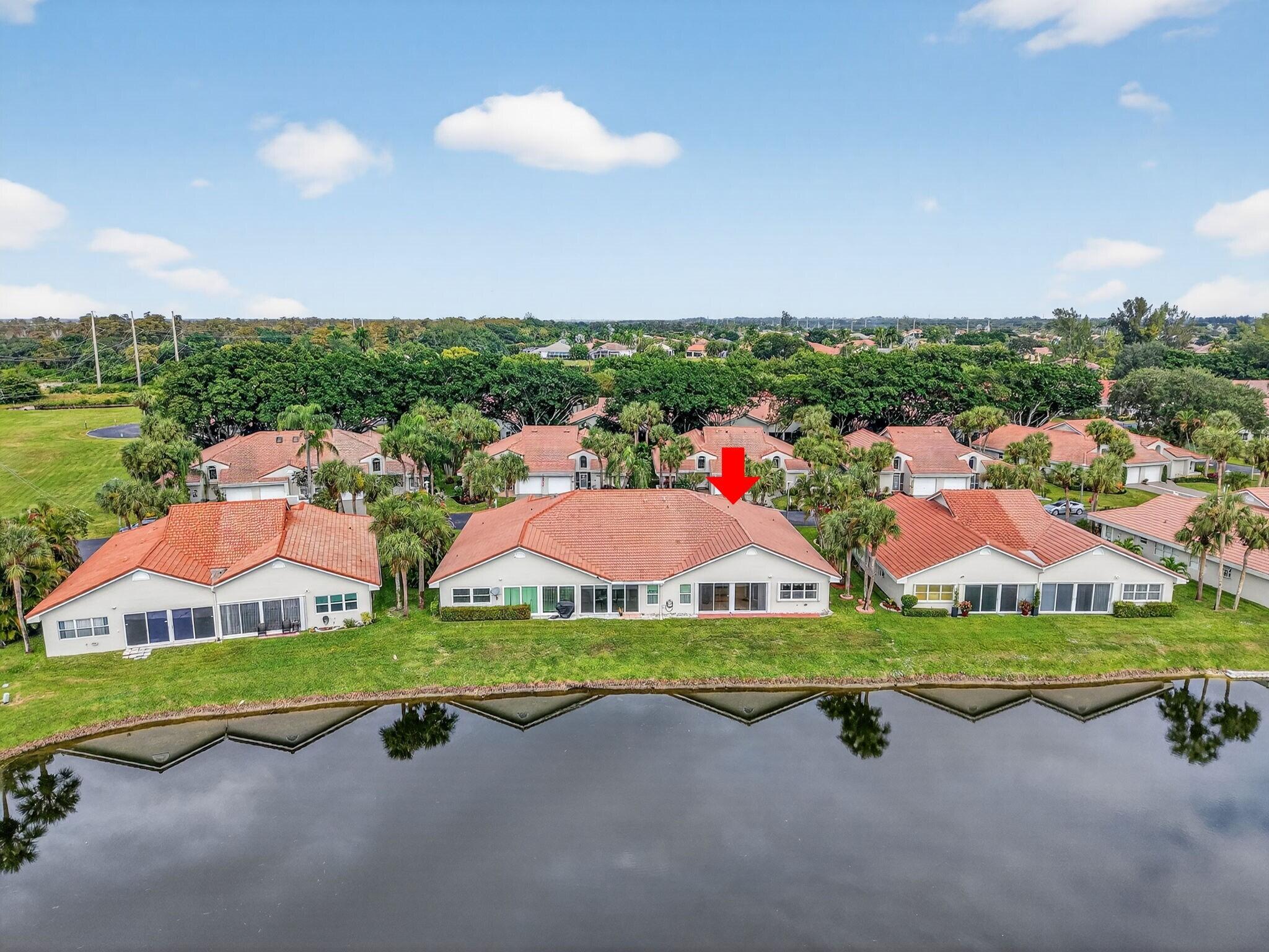 11168 Sangria Court Boca Raton, FL 33498 - Photo 2 of 63 an aerial view of a house with a garden and lake view