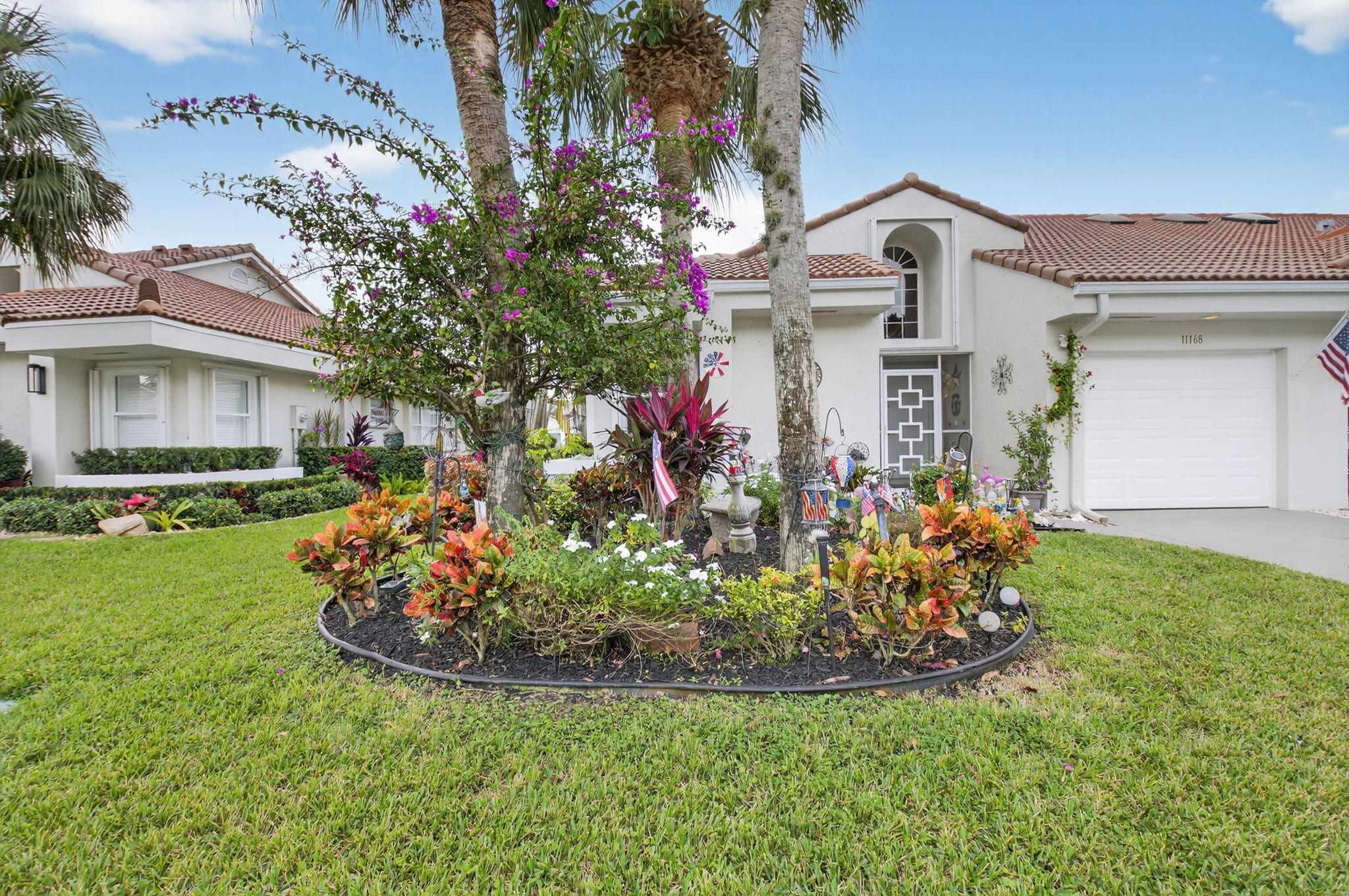 11168 Sangria Court Boca Raton, FL 33498 - Photo 37 of 63 a front view of a house with garden