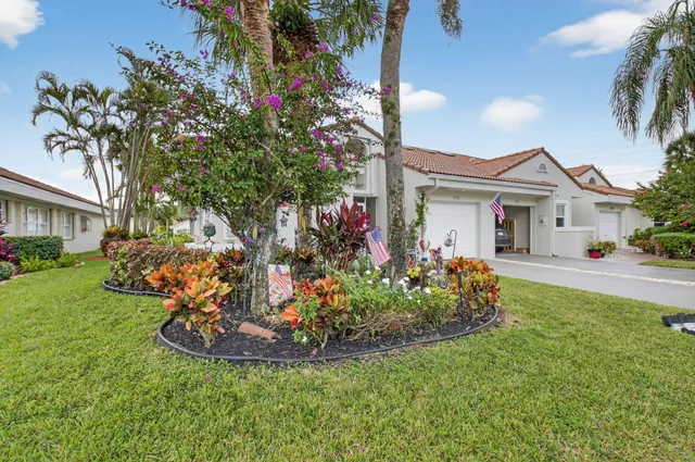 a view of a house with yard and sitting area