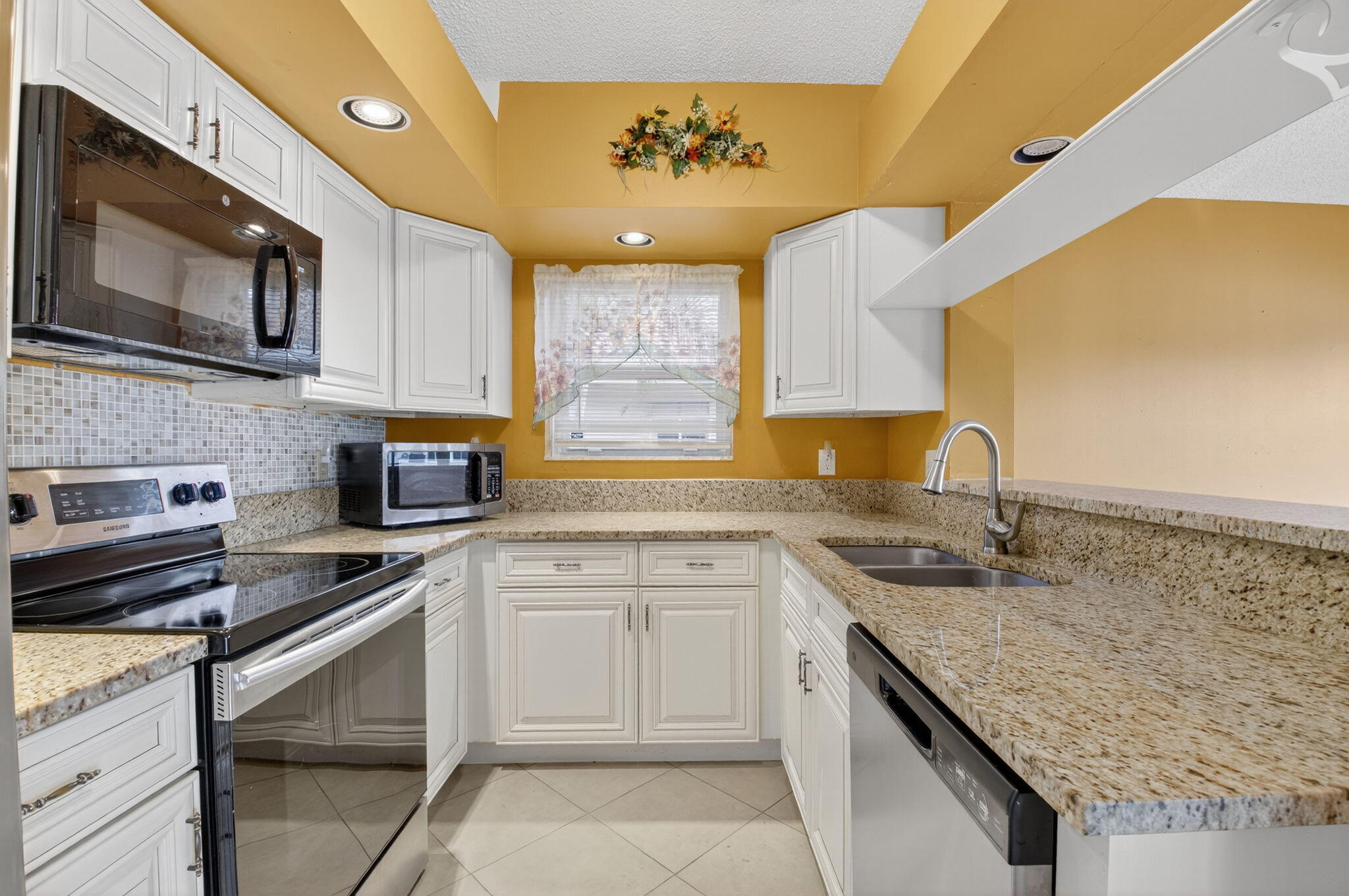 11168 Sangria Court Boca Raton, FL 33498 - Photo 6 of 63 a kitchen with stainless steel appliances granite countertop a sink stove and microwave