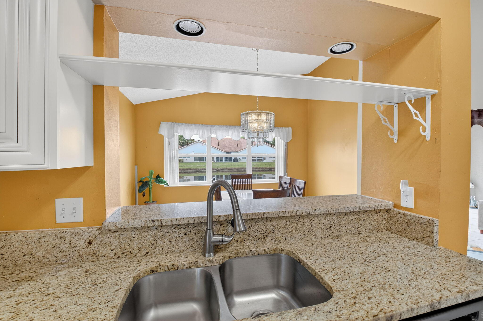 11168 Sangria Court Boca Raton, FL 33498 - Photo 9 of 63 a kitchen with granite countertop a sink and a window