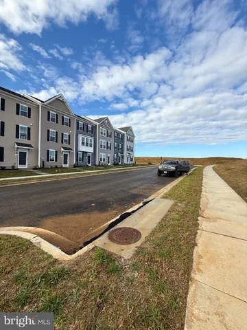 a view of a house with a swimming pool and sitting area