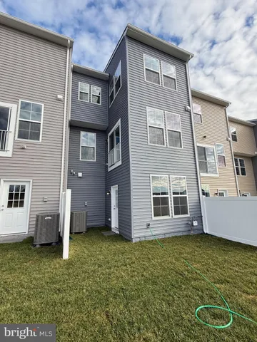 a view of a hallway with wooden floor and entryway