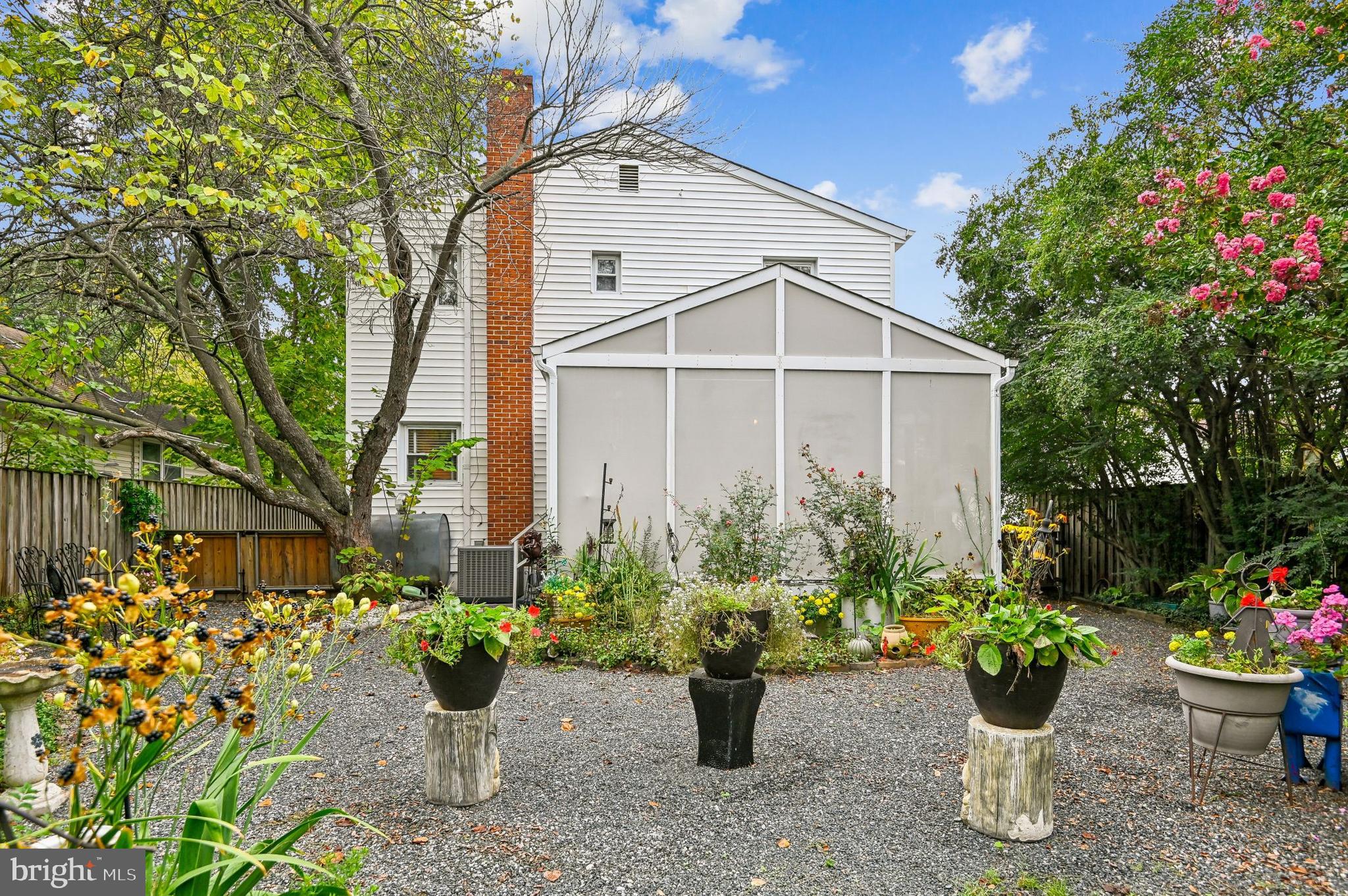 9941 Naylor Avenue Laurel, MD 20723 - Photo 19 of 30 a white house with a yard and sitting area