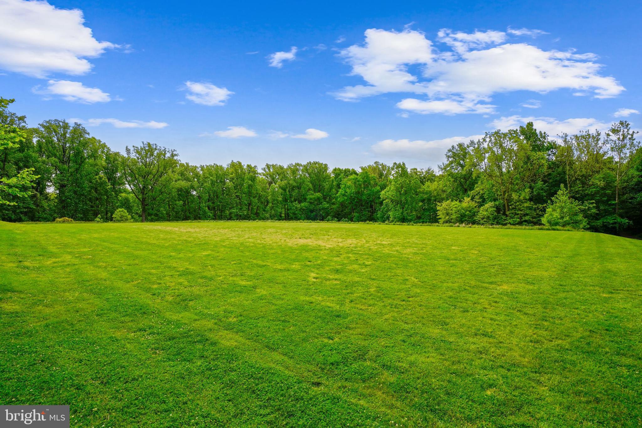 9941 Naylor Avenue Laurel, MD 20723 - Photo 29 of 30 a view of a green field with a building in the background