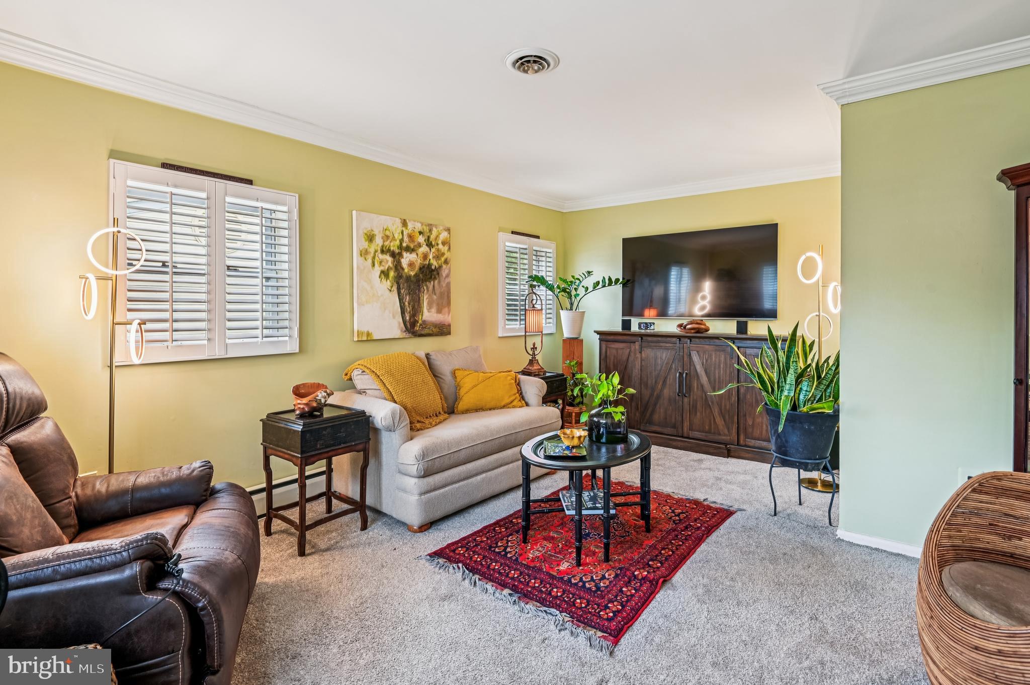 9941 Naylor Avenue Laurel, MD 20723 - Photo 4 of 30 a living room with furniture a rug and a flat screen tv