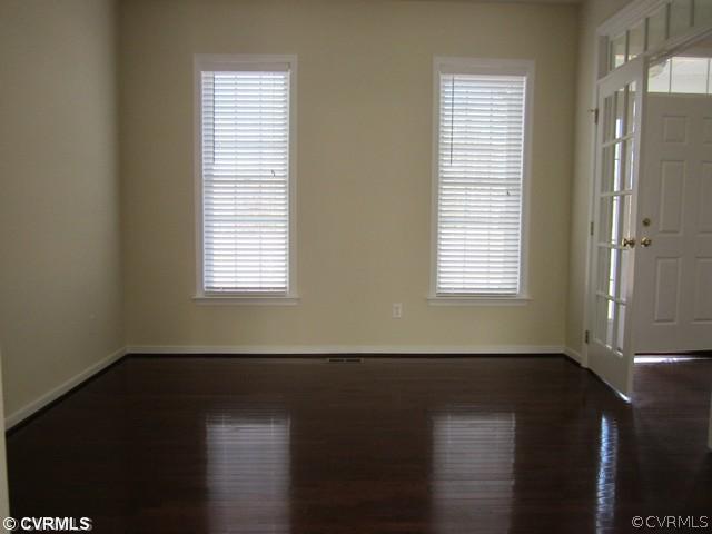3001 Kinvan Road Henrico, VA 23231 - Photo 2 of 13 a view of an empty room with wooden floor and a window