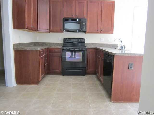 3001 Kinvan Road Henrico, VA 23231 - Photo 5 of 13 a kitchen with granite countertop a refrigerator and a stove top oven