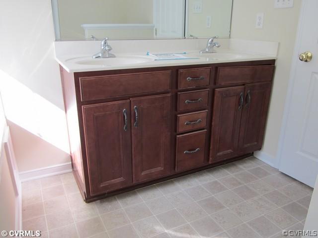 3001 Kinvan Road Henrico, VA 23231 - Photo 9 of 13 a bathroom with a sink vanity and mirror