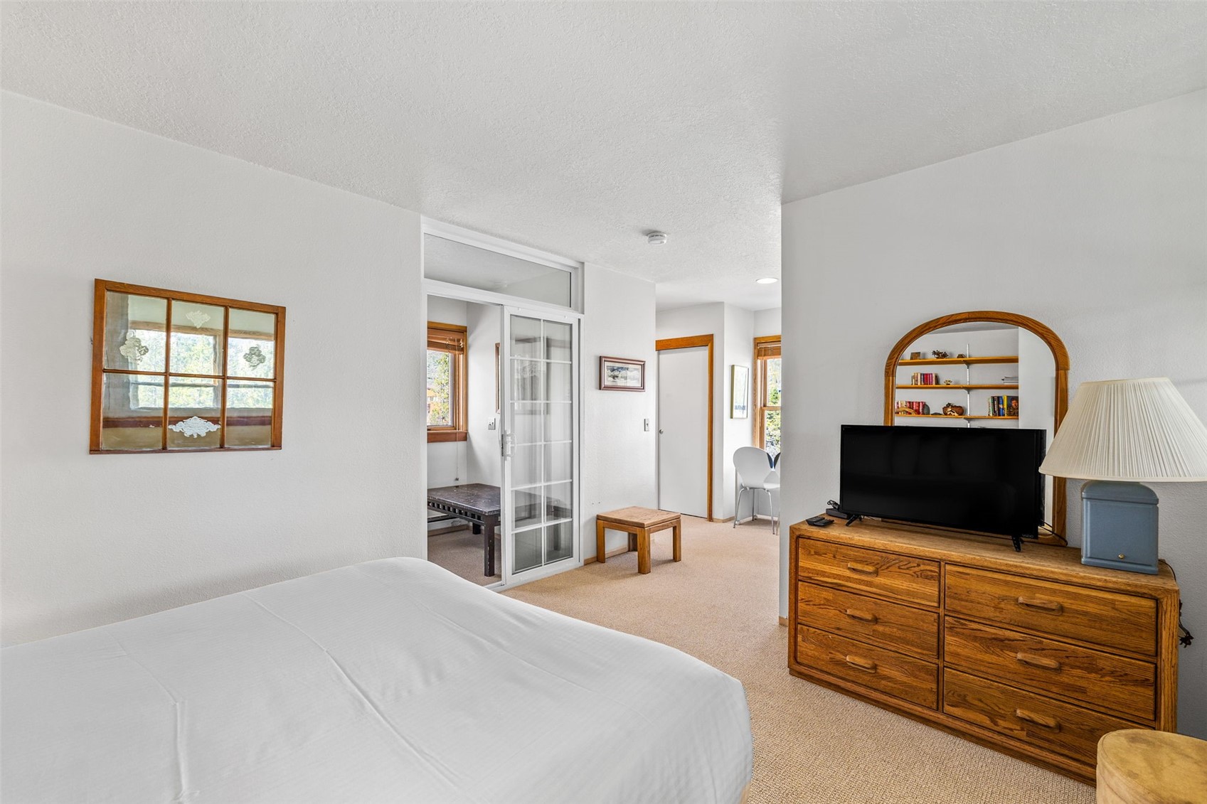 240 Tennis Club Road, Unit 1677 Keystone, CO 80435 - Photo 26 of 46 Bedroom featuring light carpet, multiple windows, and a textured ceiling