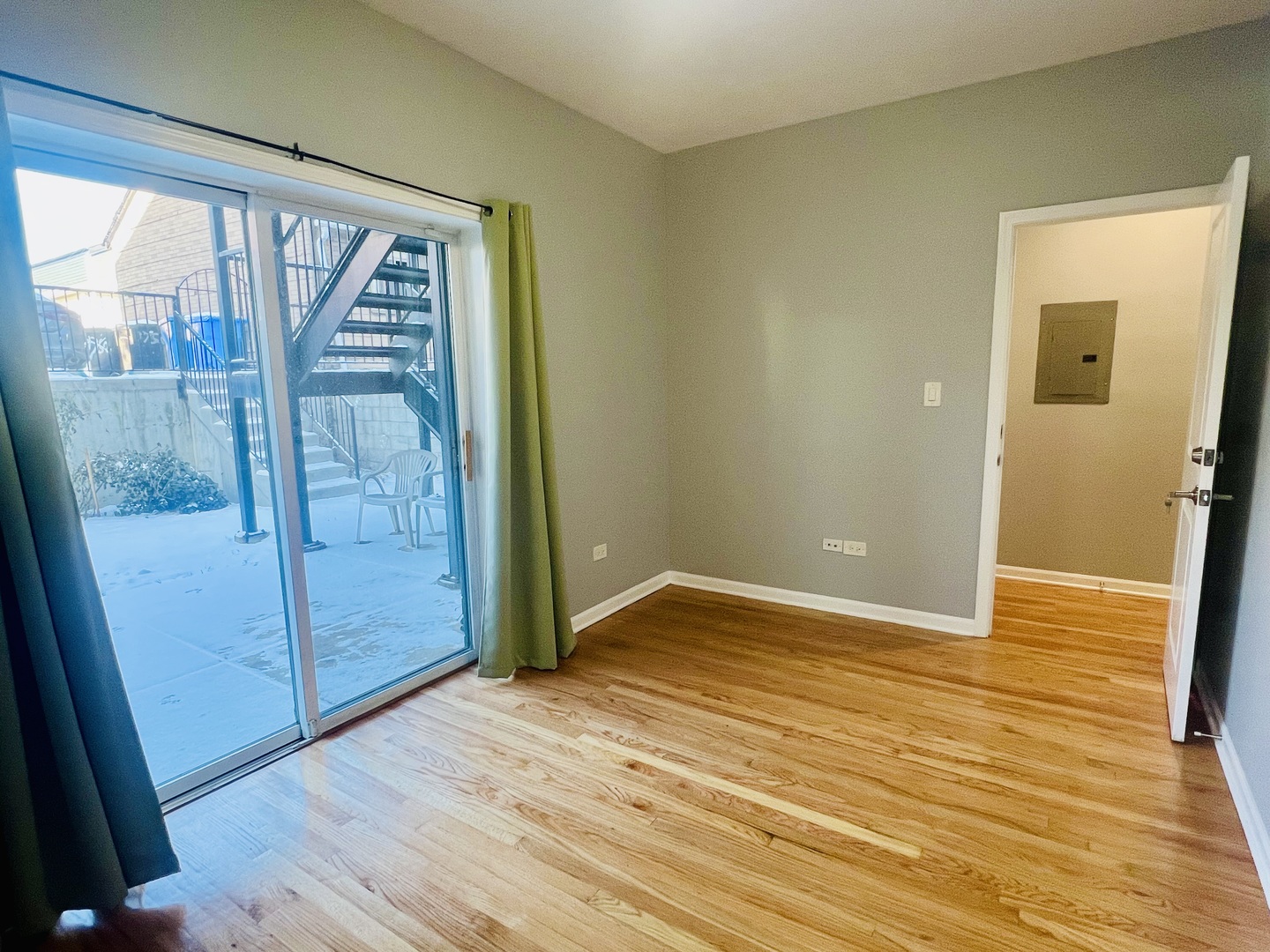 1750 West Cermak Road, Unit B Chicago, IL 60608 - Photo 14 of 18 a view of an empty room with wooden floor and a window