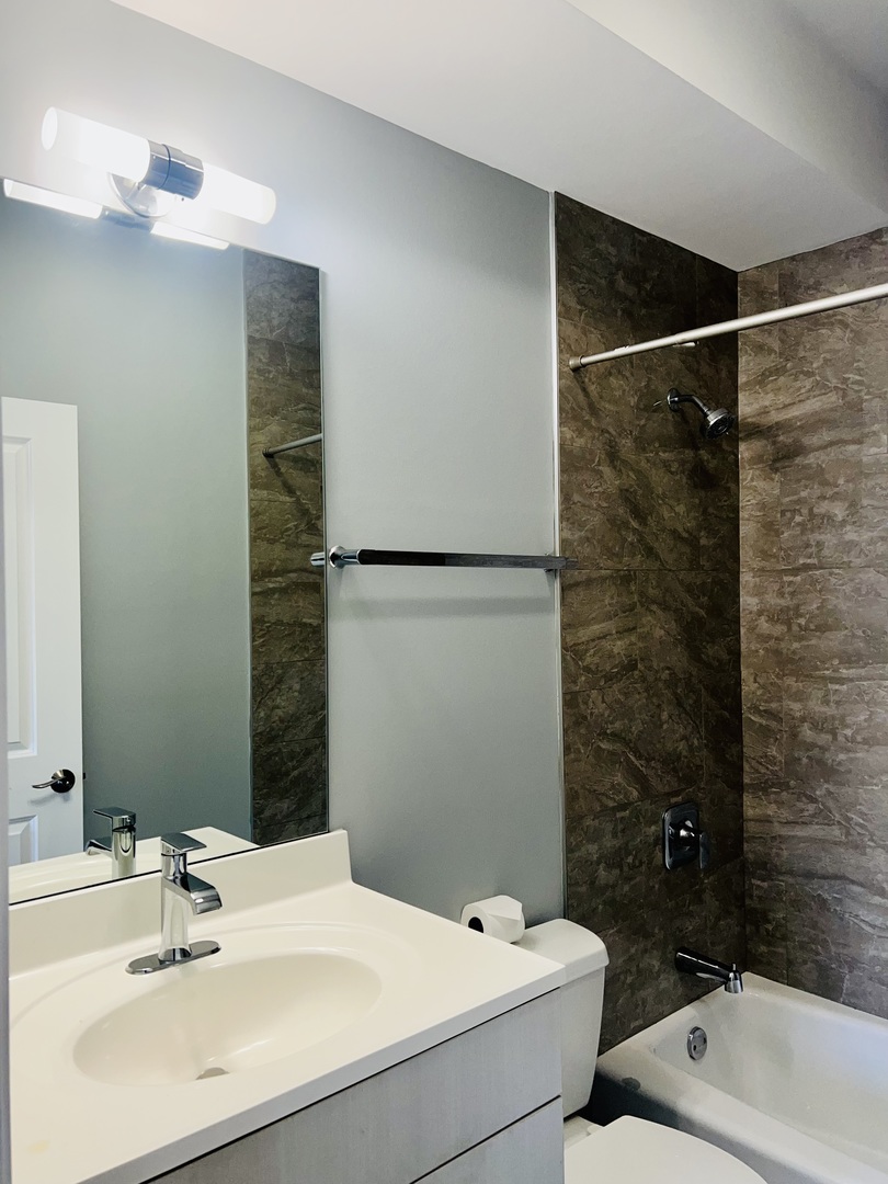 1750 West Cermak Road, Unit B Chicago, IL 60608 - Photo 18 of 18 a bathroom with a sink and a mirror