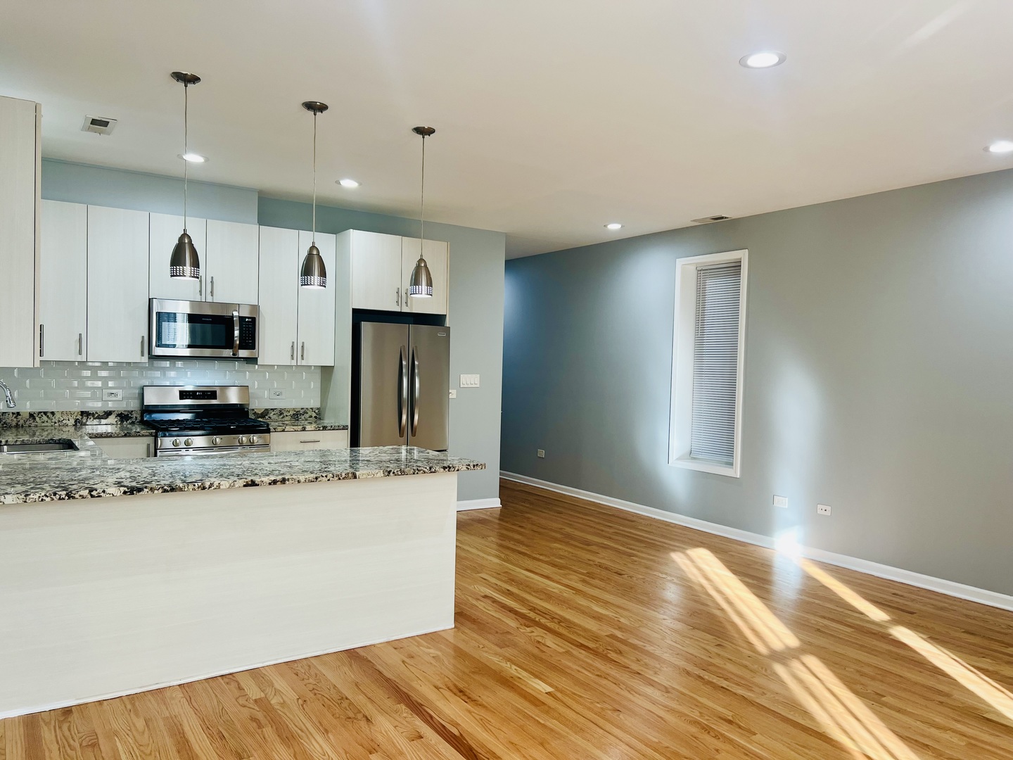 1750 West Cermak Road, Unit B Chicago, IL 60608 - Photo 4 of 18 a kitchen with stainless steel appliances a sink a stove a microwave and cabinets
