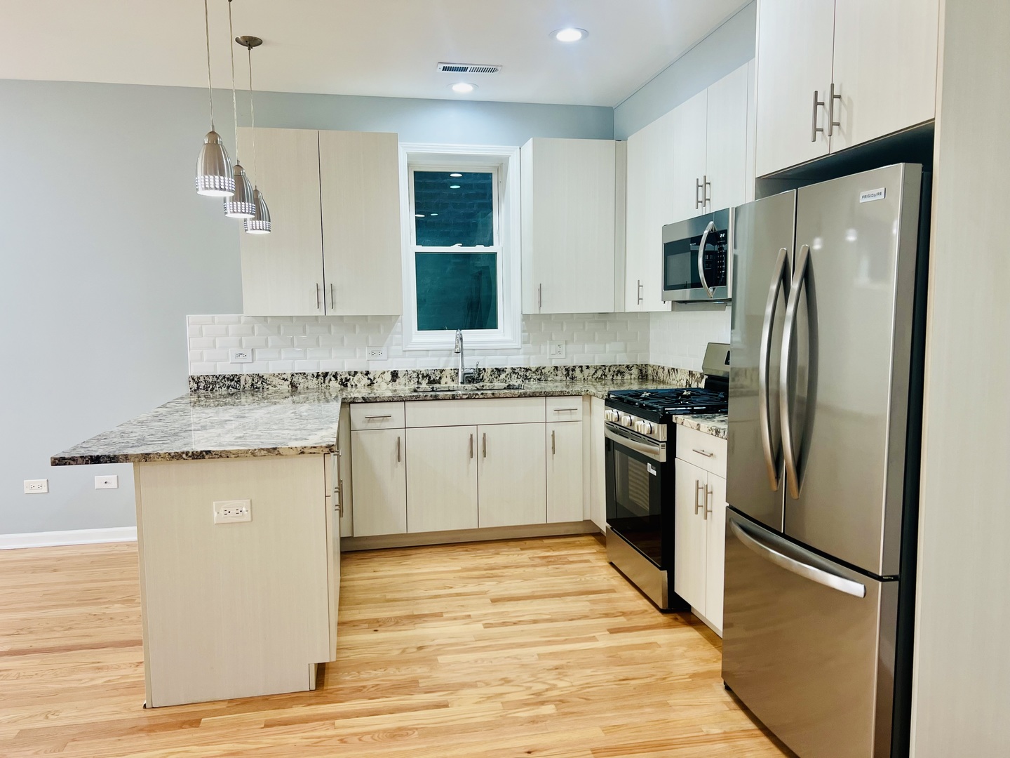 1750 West Cermak Road, Unit B Chicago, IL 60608 - Photo 6 of 18 a kitchen with stainless steel appliances granite countertop a refrigerator sink and stove