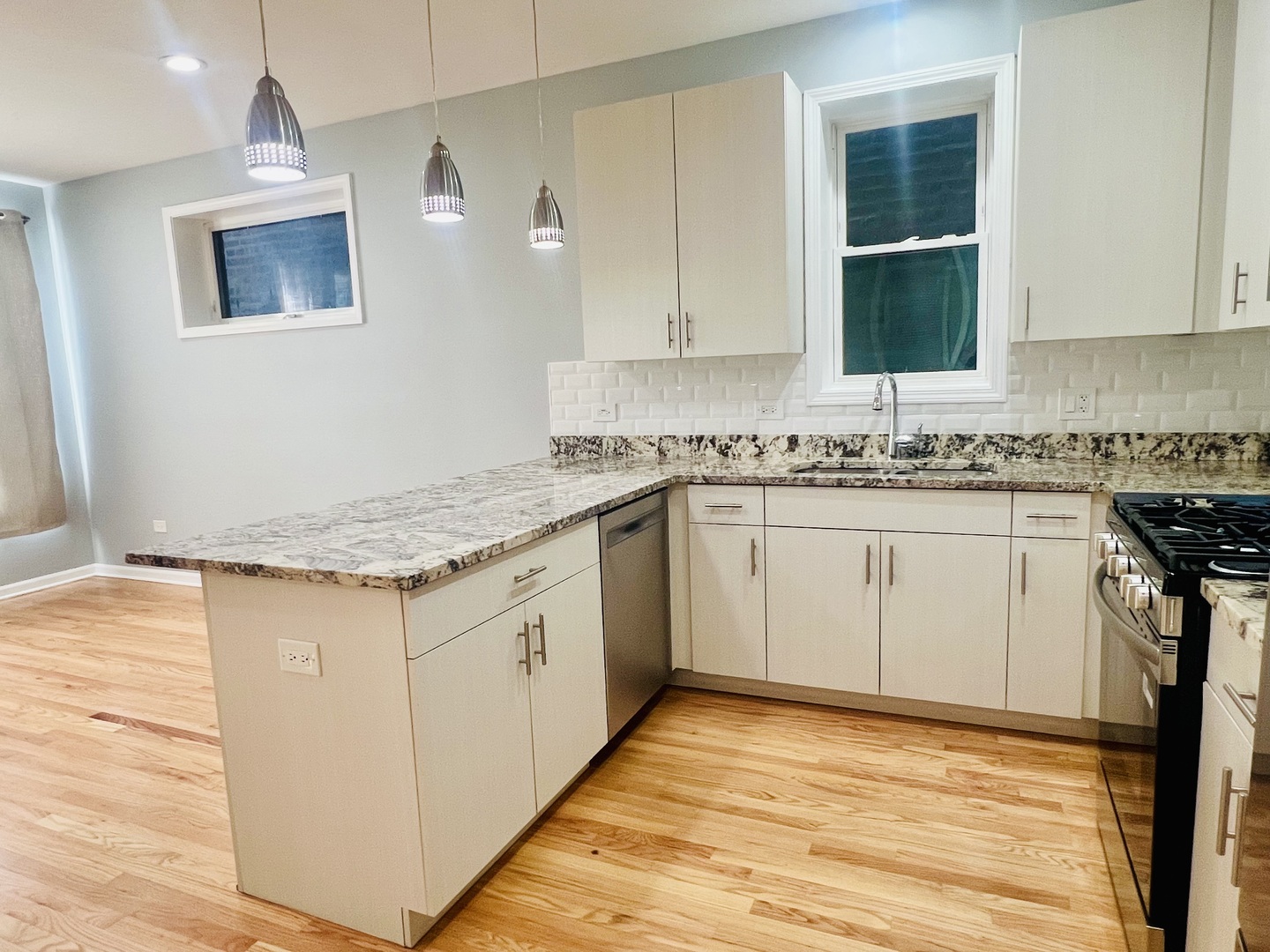 1750 West Cermak Road, Unit B Chicago, IL 60608 - Photo 8 of 18 a kitchen with a sink stove and cabinets