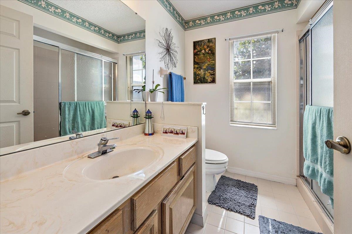 100 North Lake Circle St. Augustine, FL 32084 - Photo 13 of 25 a bathroom with a sink a toilet and a mirror