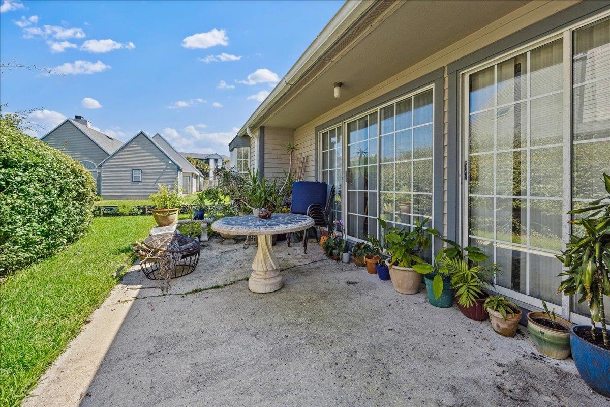 100 North Lake Circle St. Augustine, FL 32084 - Photo 14 of 25 a view of a patio with table and chairs and potted plants