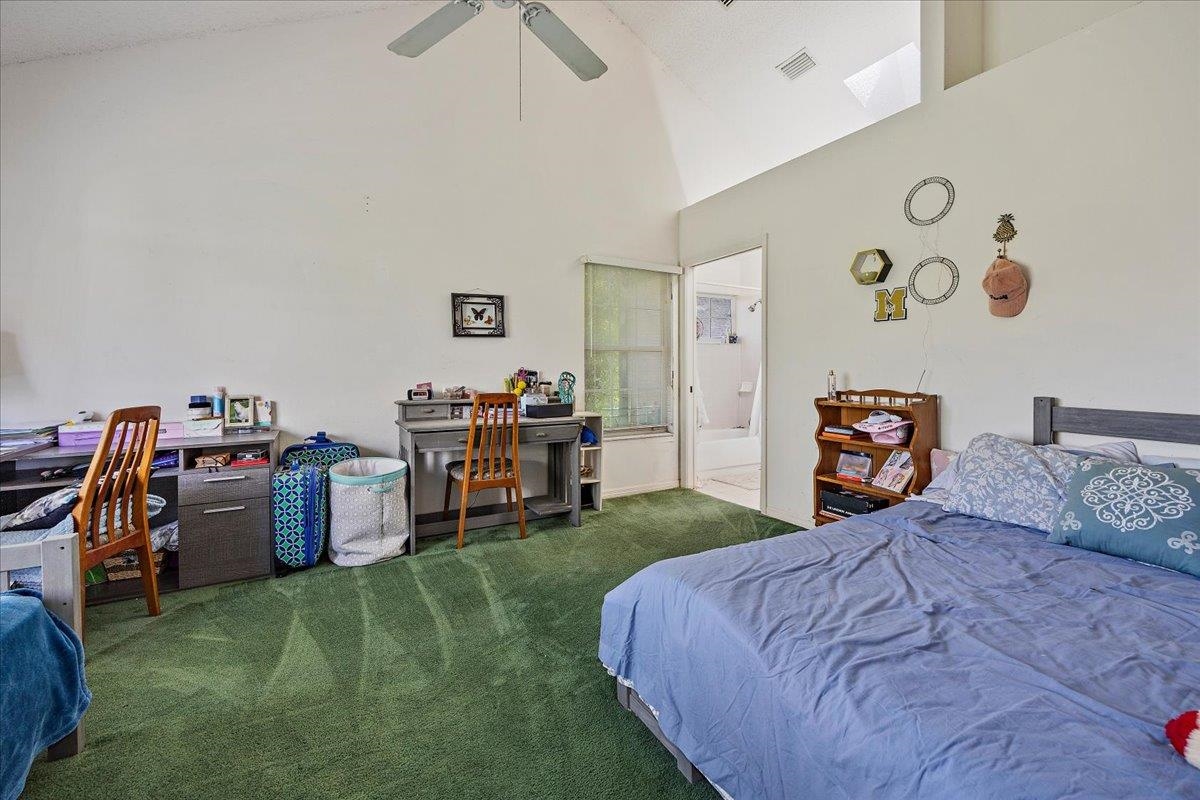 100 North Lake Circle St. Augustine, FL 32084 - Photo 8 of 25 a bedroom with a bed and a bookshelf