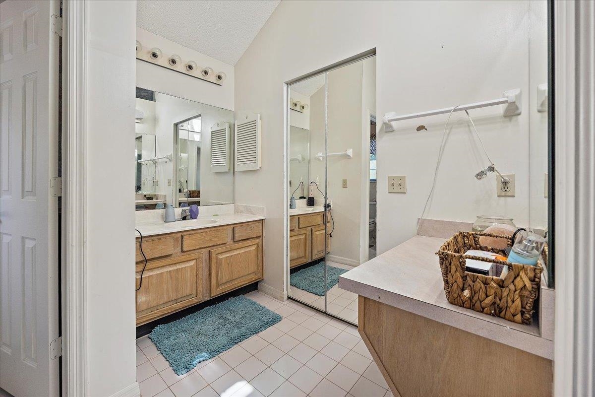 100 North Lake Circle St. Augustine, FL 32084 - Photo 10 of 25 a spacious bathroom with a double vanity sink a mirror and a shower