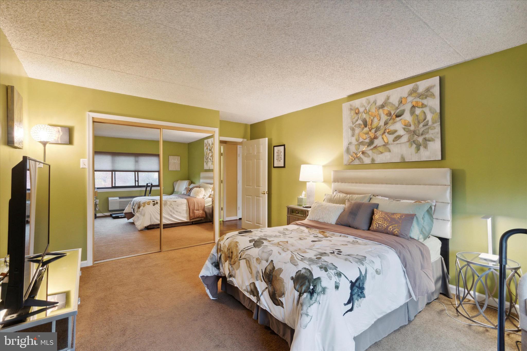 800 Avondale Road, Unit 5L Wallingford, PA 19086 - Photo 16 of 25 a bedroom with a bed couch and a large window