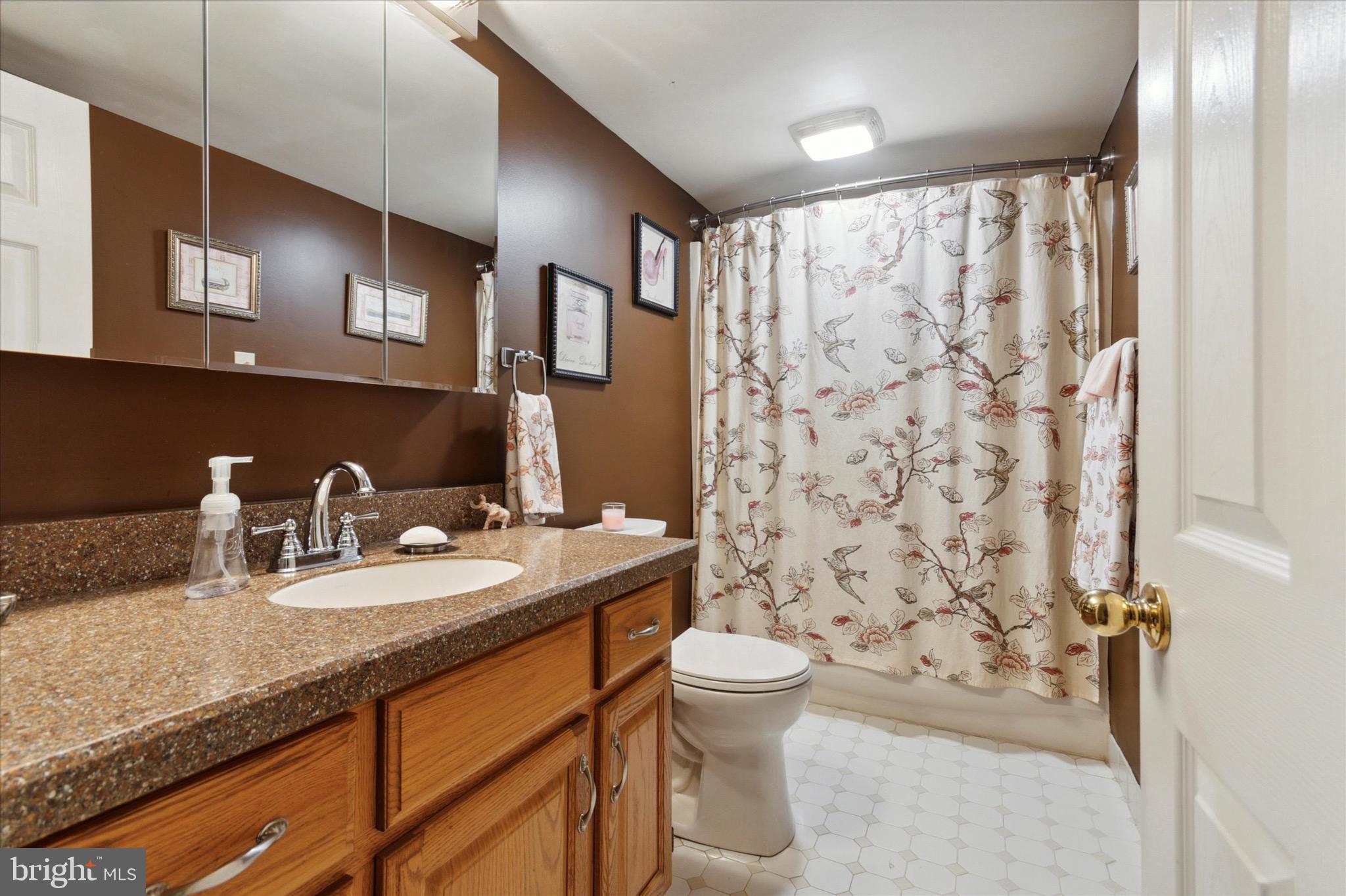 800 Avondale Road, Unit 5L Wallingford, PA 19086 - Photo 17 of 25 a bathroom with a granite countertop sink toilet and shower