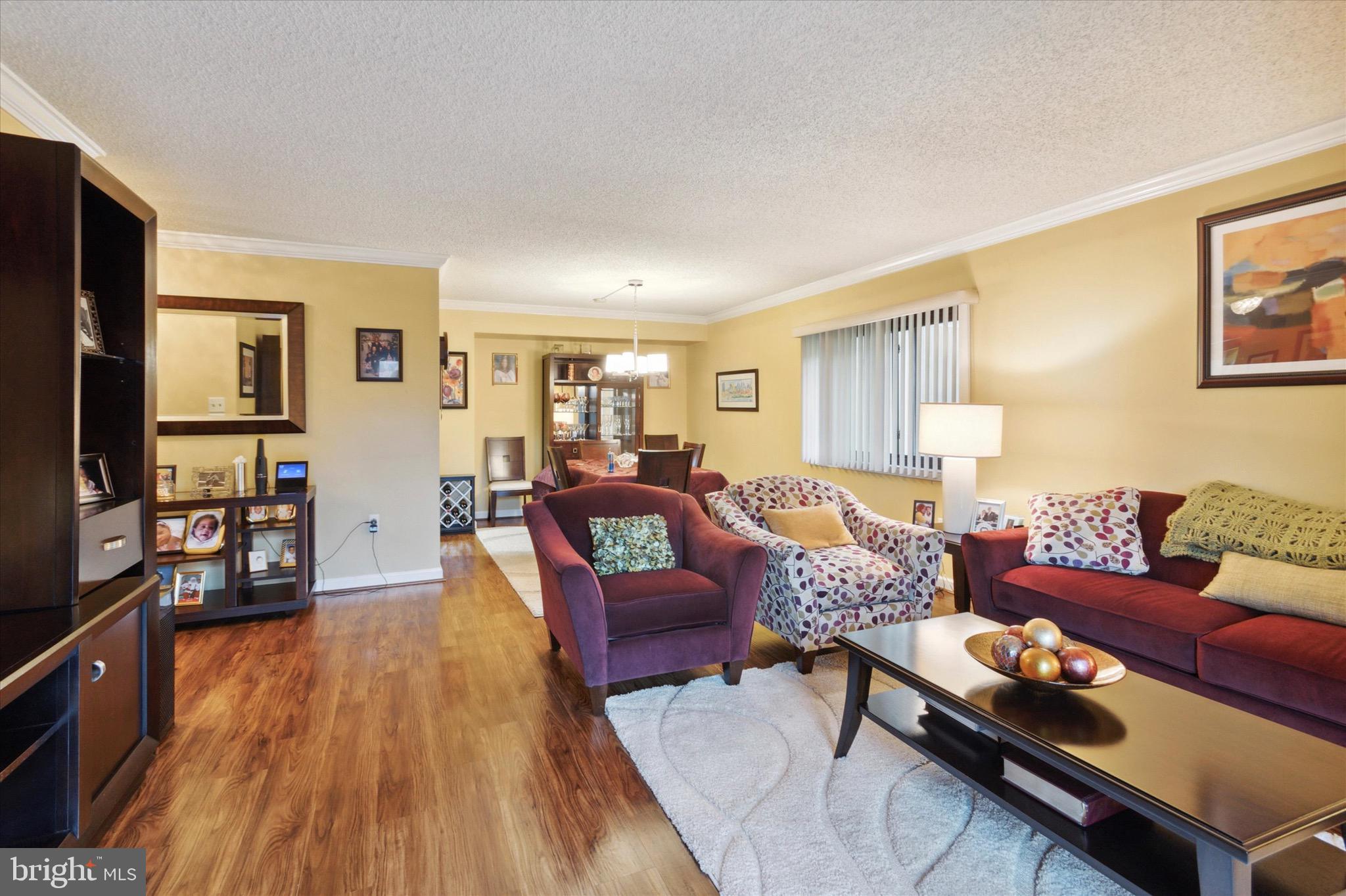 800 Avondale Road, Unit 5L Wallingford, PA 19086 - Photo 2 of 25 a living room with furniture and a wooden floor