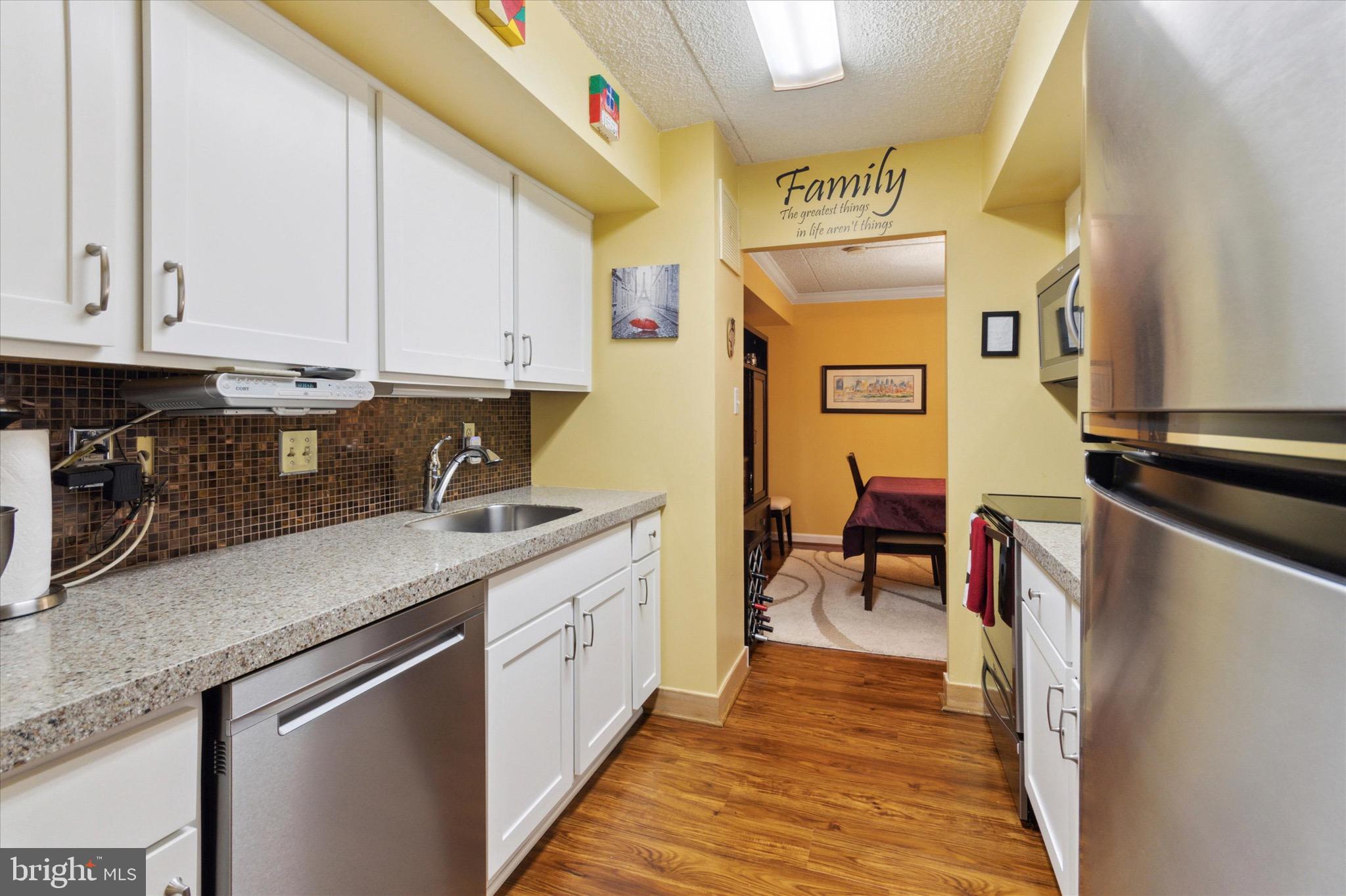 800 Avondale Road, Unit 5L Wallingford, PA 19086 - Photo 9 of 25 a kitchen with stainless steel appliances granite countertop a stove a sink and a refrigerator