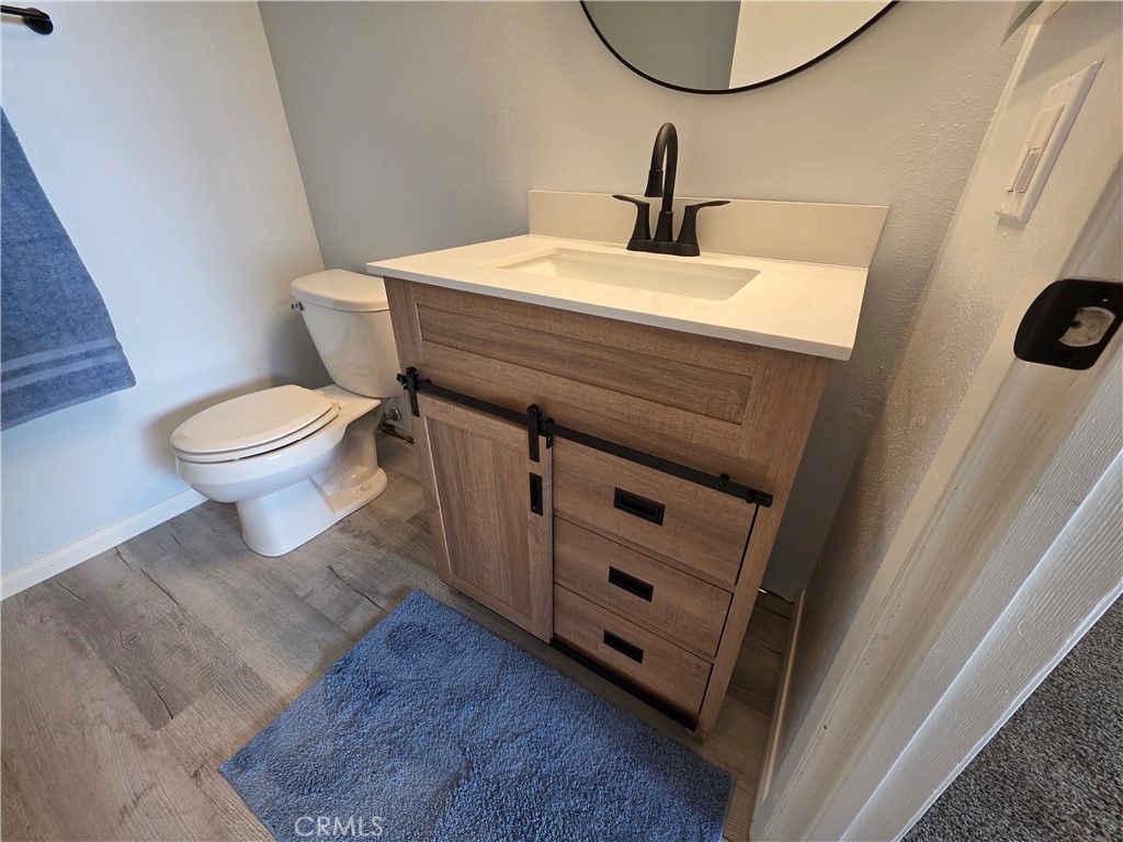 850 Vallejo Avenue Simi Valley, CA 93065 - Photo 26 of 50 a bathroom with a sink a toilet and a mirror