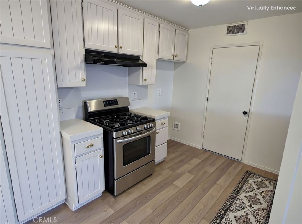 850 Vallejo Avenue Simi Valley, CA 93065 - Photo 6 of 50 a kitchen with granite countertop a stove and a refrigerator